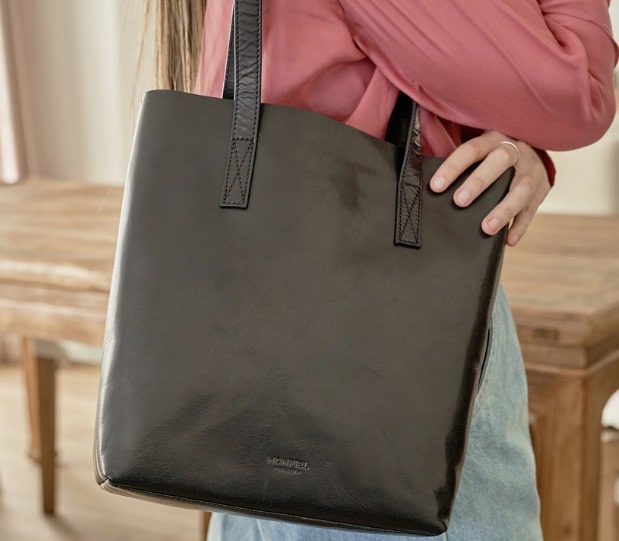 Elegancia ligera y funcionalidad con bolsa interior con cremallera. Piel 100% natural en negro y cuero. Simplifica tu día a día con estilo.