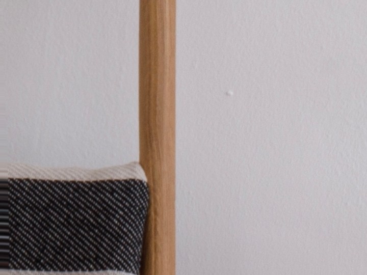 Modern,Bedroom,With,White,Walls,,Wooden,Floors,,And,Handmade,Furniture.